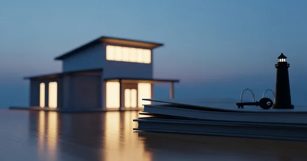 Miniature house, lighthouse, and key sit atop a stack of books.