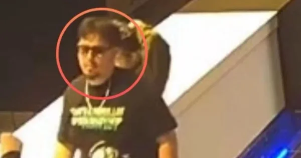 A surveillance image highlights a person of interest sought for questioning in connection with an ongoing investigation.