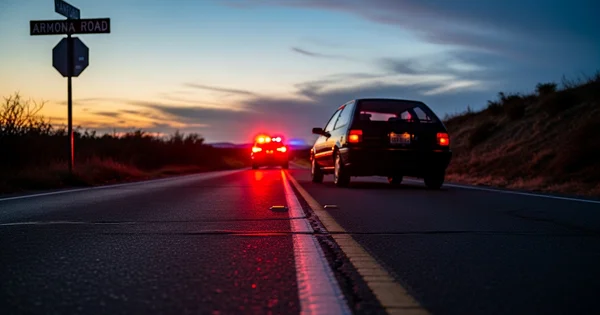 Law enforcement conducts a traffic stop on Armona Road near Hanford at dusk.
