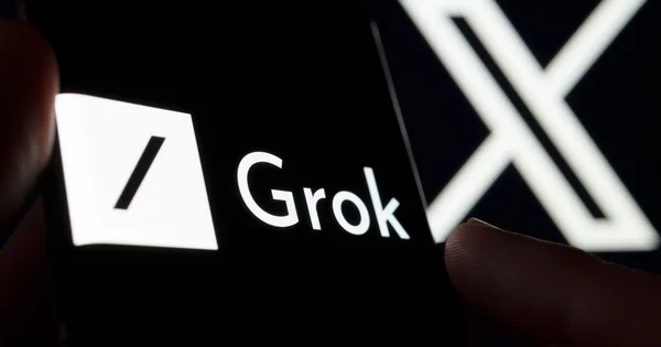 A smartphone displays the logo for Grok, an AI chatbot developed by xAI.