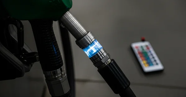 A conceptual fuel pump nozzle features an illuminated blue display integrated into the hose connector.