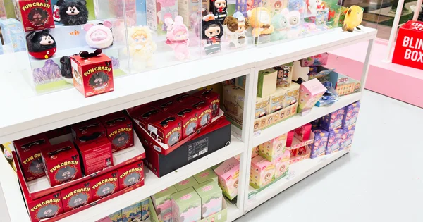 A retail display features a variety of popular blind box collectible figurines and plush toys.