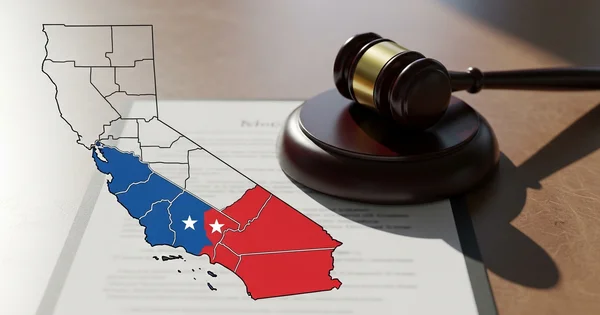 A gavel rests on a document with an outline of the state of California divided into blue and red sections.