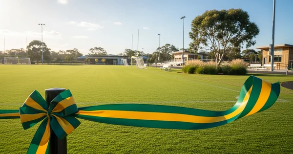 A green and yellow ceremonial ribbon signals the grand opening of a new multi-purpose athletic facility.