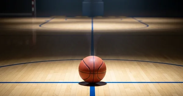 A basketball sits on center court.